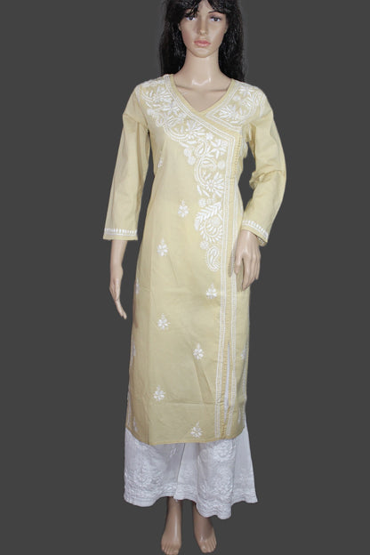 A pale yellow kurta with white floral embroidery, styled with a white skirt, displayed on a female mannequin against a dark gray background.