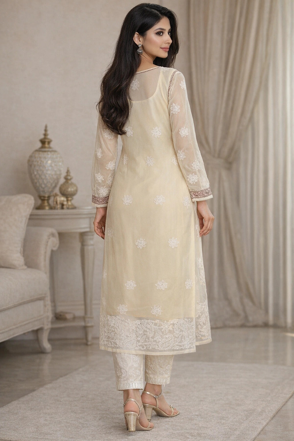 Woman wearing a beige lucknowi chikankari traditional outfit in a stylish room.