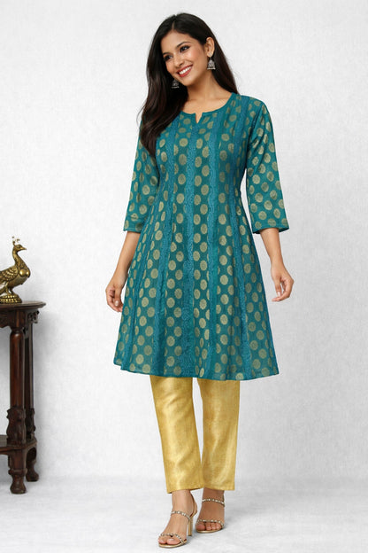 Woman wearing a teal and gold patterned kurta with yellow pants on a white background