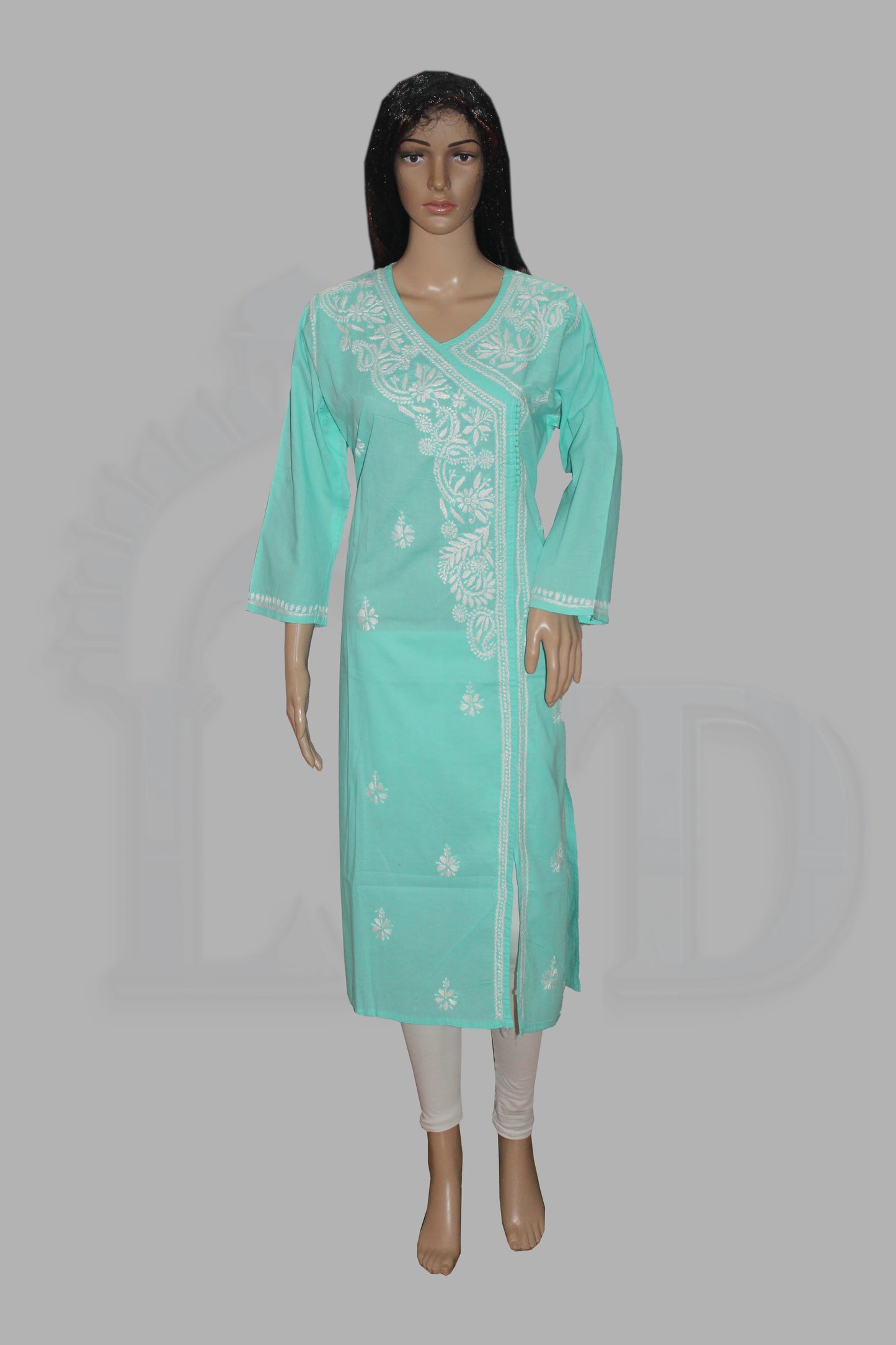 A mint green kurta with white floral embroidery on the front panel and cuffs, modeled on a mannequin against a solid gray background.