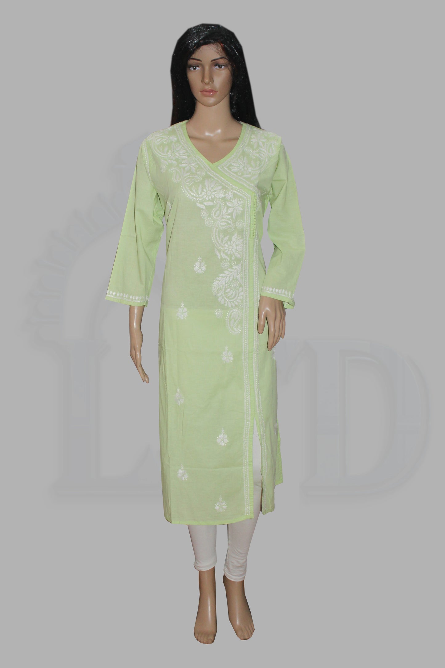 A light green long kurta with white floral embroidery, displayed on a female mannequin against a solid gray background.