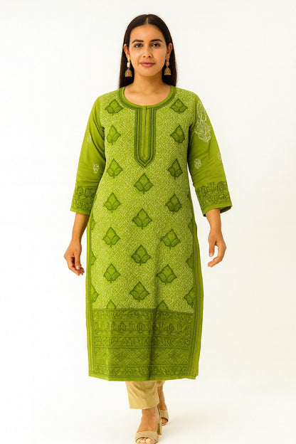 Woman wearing a lucknowi chikankari green patterned kurta with beige pants on a white background
