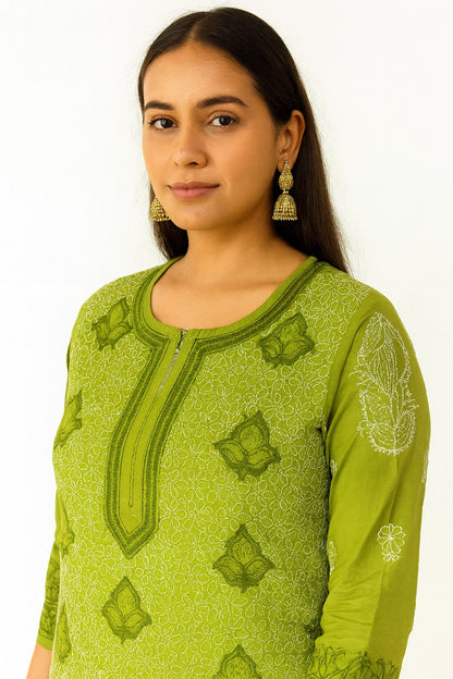 Woman wearing a lucknowi chikankari green patterned top against a white background