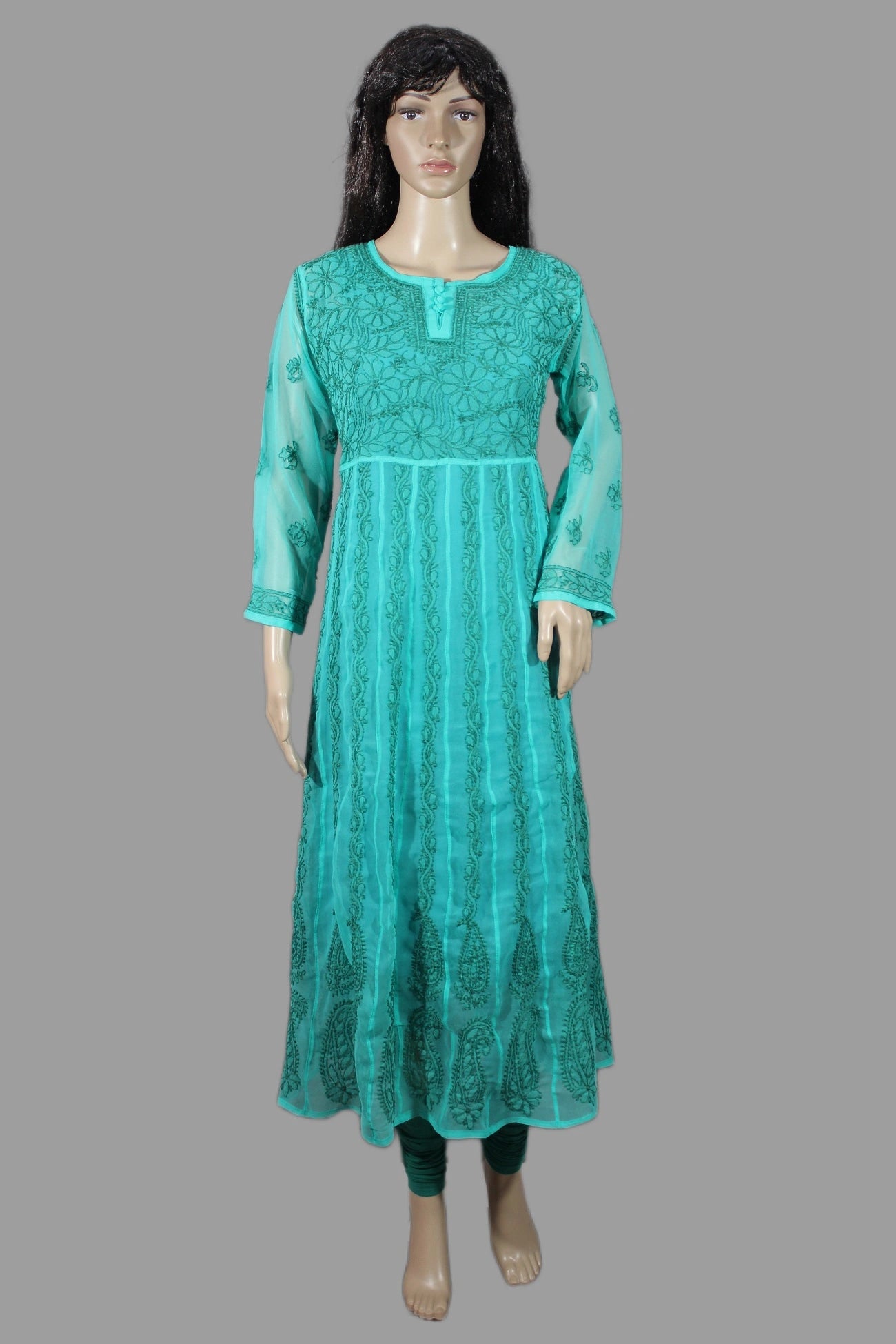 Teal dress on a mannequin against a gray background