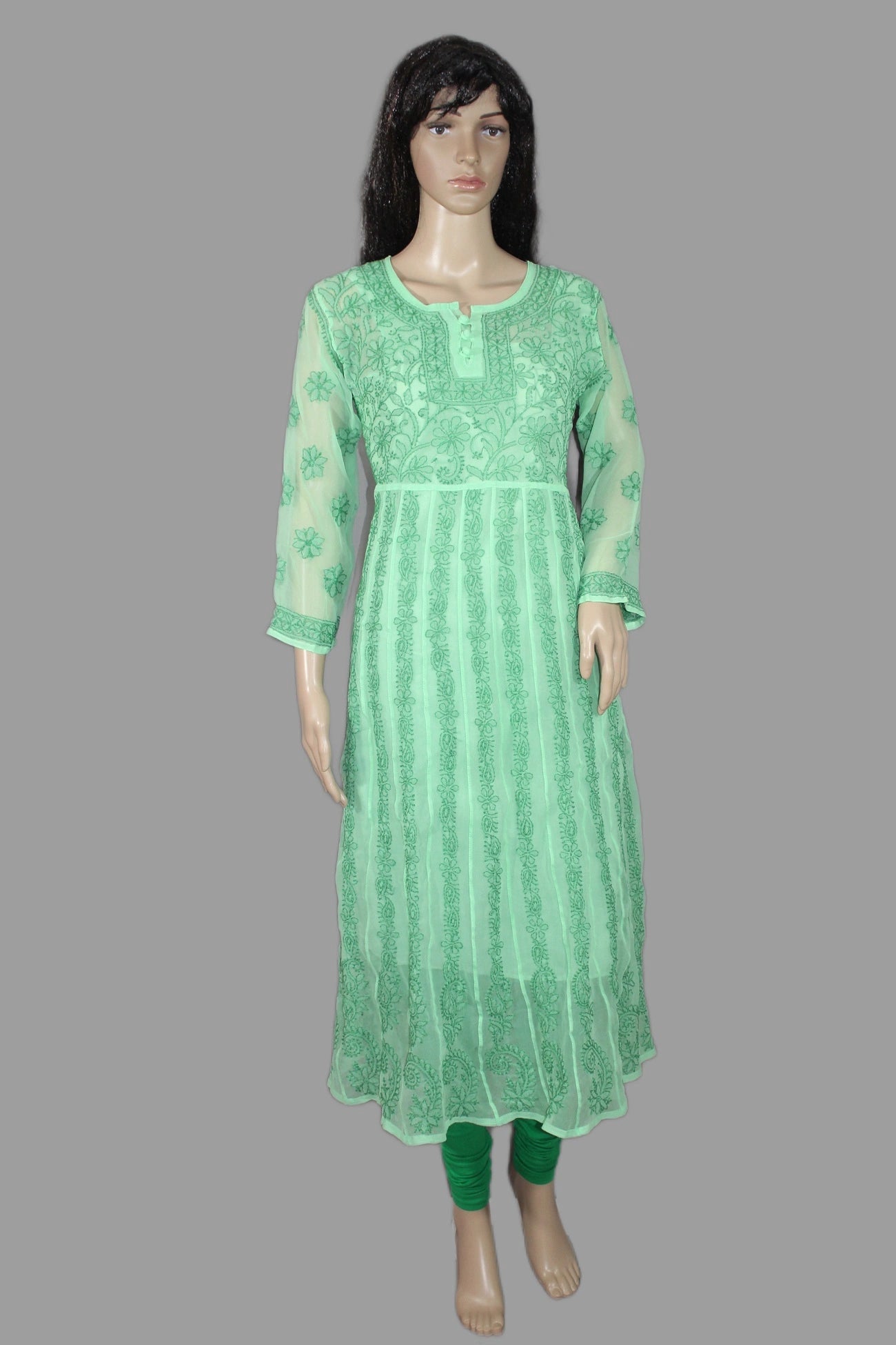 Green embroidered kurta on a mannequin against a gray background