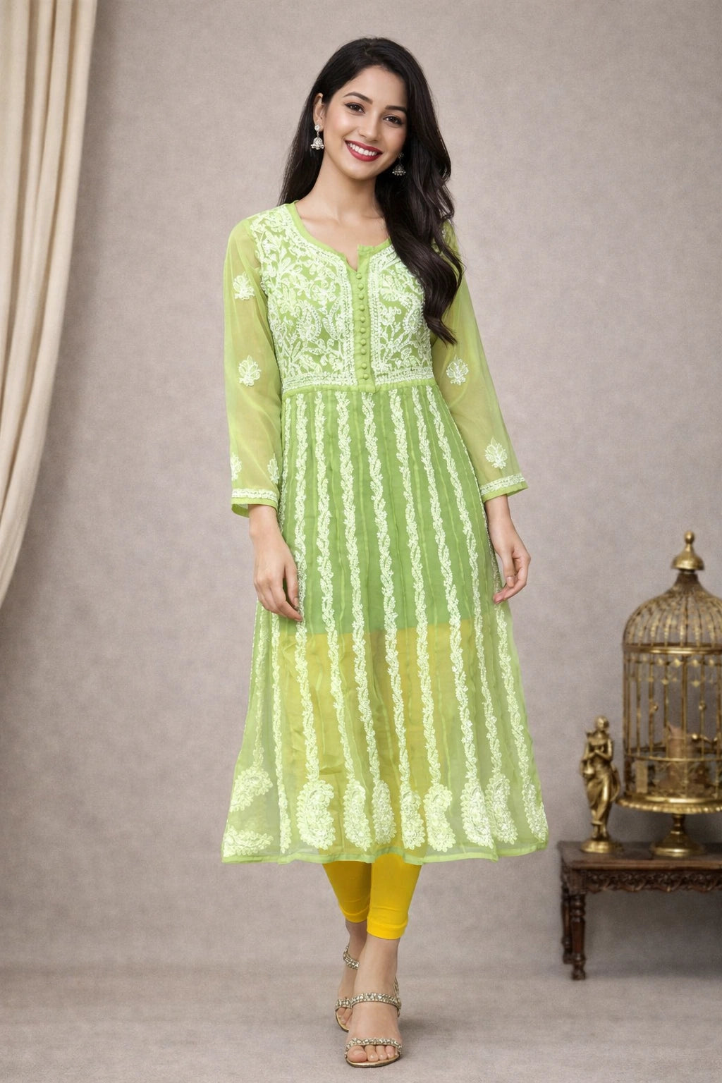 Woman wearing a green embroidered kurta with yellow pants against a neutral background