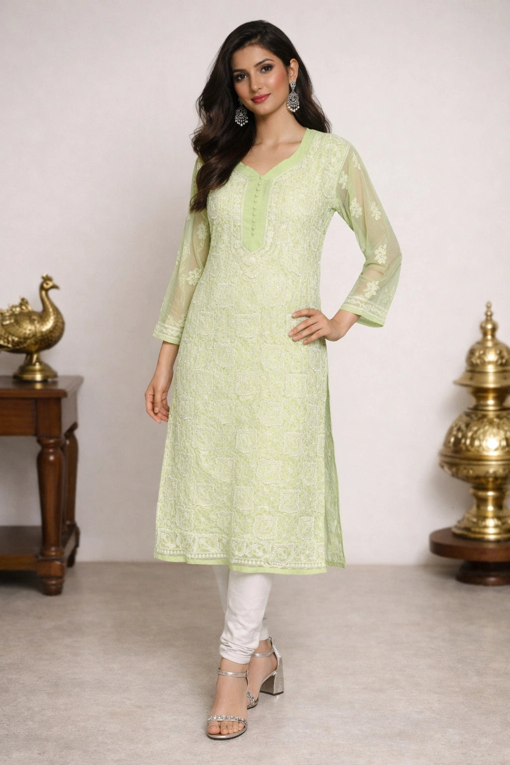 Woman wearing a lucknowi chikankari light green kurta with white pants in a minimalistic setting.