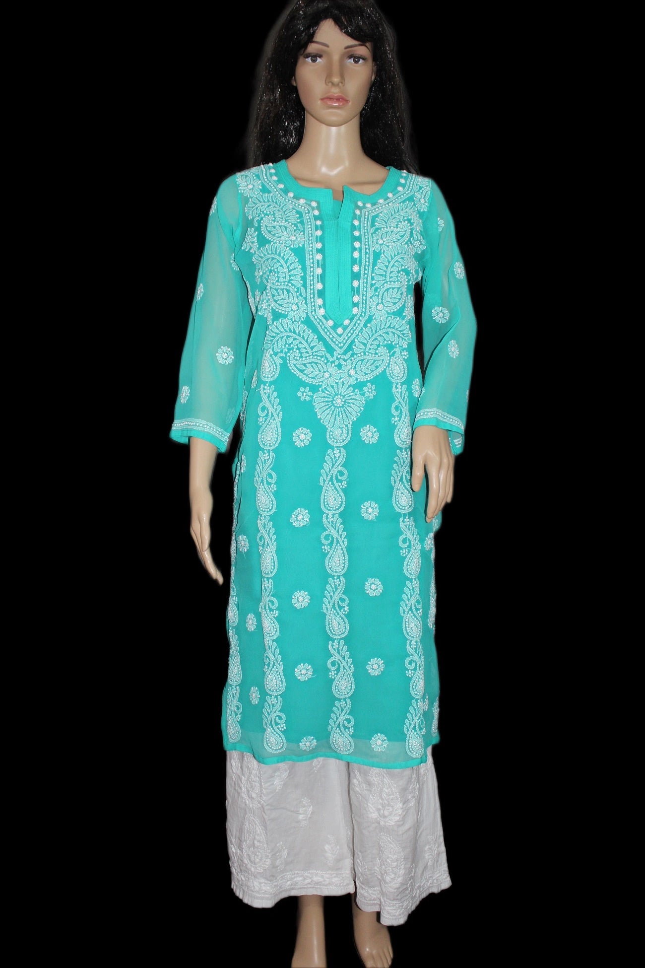 Teal embroidered kurta with white patterns on a black background