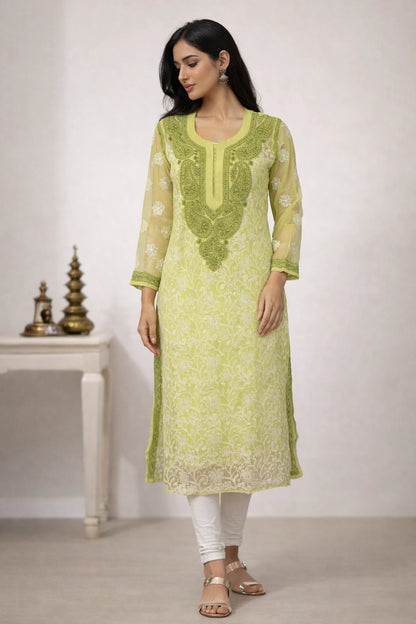 Woman wearing a light green embroidered kurta with white pants against a plain background