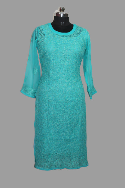 Teal lace dress on a mannequin against a gray background