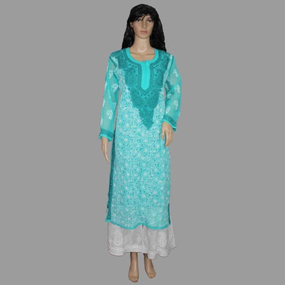 Turquoise embroidered dress on a mannequin against a gray background