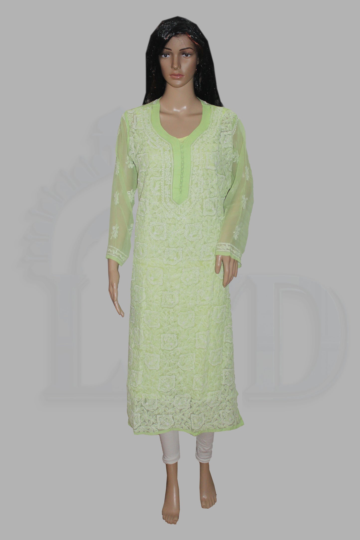 Light green lace dress on a mannequin against a gray background
