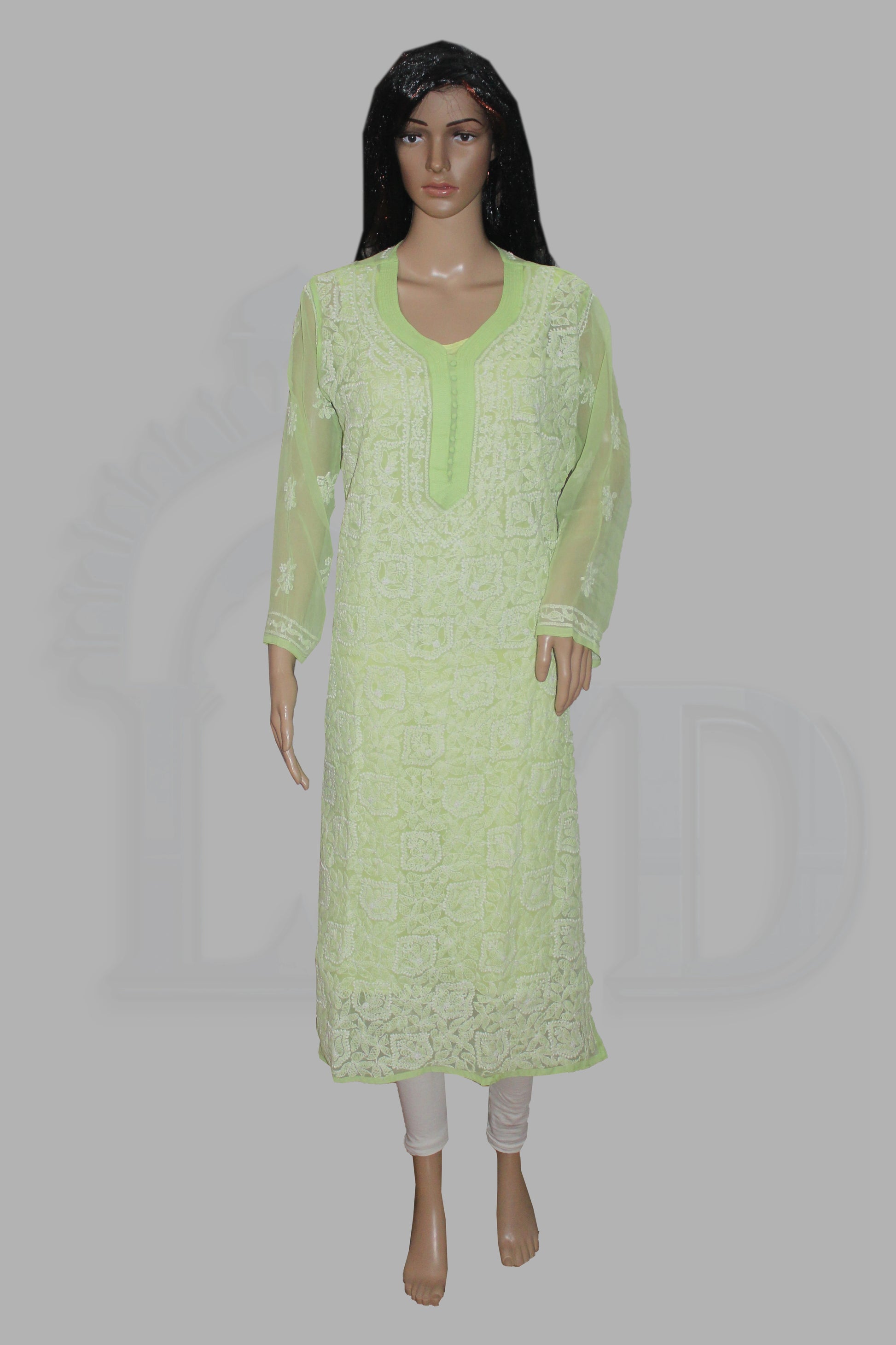 Light green lace dress on a mannequin against a gray background