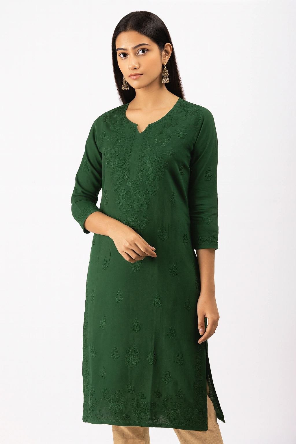 Woman wearing a lucknowi chikankari green kurta against a white background
