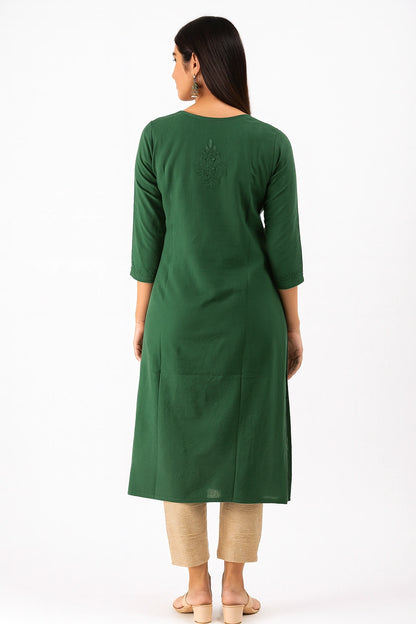Woman wearing a lucknowi chikankari  green kurta with beige pants on a white background