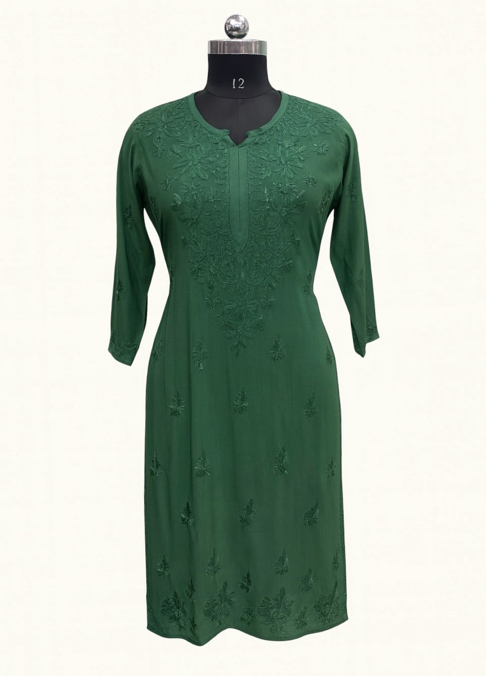 lucknowi chikankari Green dress on a mannequin against a white background