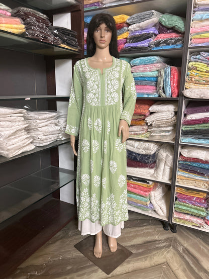 Green kurta with white floral embroidery on a beige background