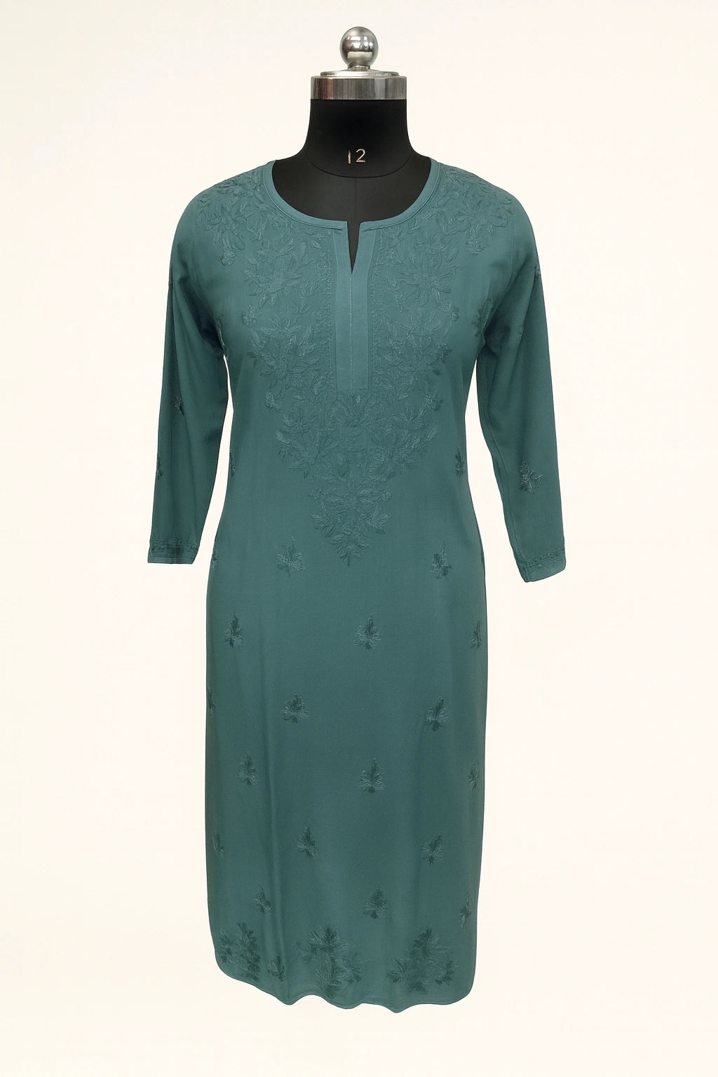 Lucknowi chikankari Teal dress on a mannequin against a white background