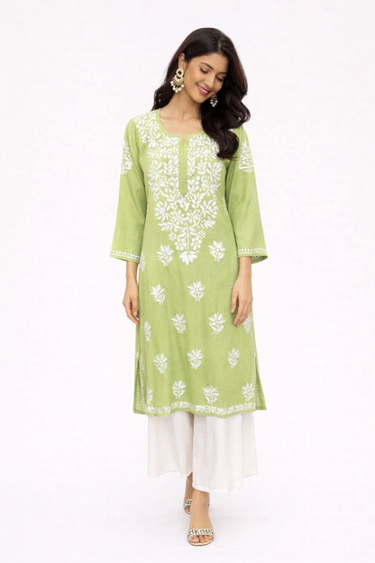 Woman wearing a green kurta with white floral embroidery on a white background