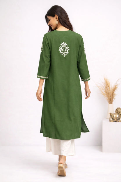 Woman wearing a green kurta with white embroidery on a white background