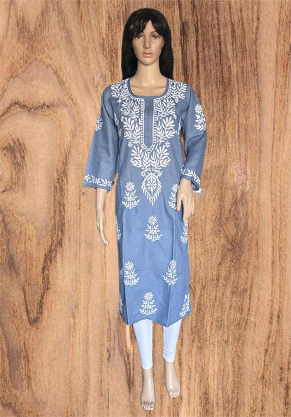 A woman wearing a light gray long-sleeve kurta with white floral embroidery and a buttoned neckline, posed against a solid dark gray background.