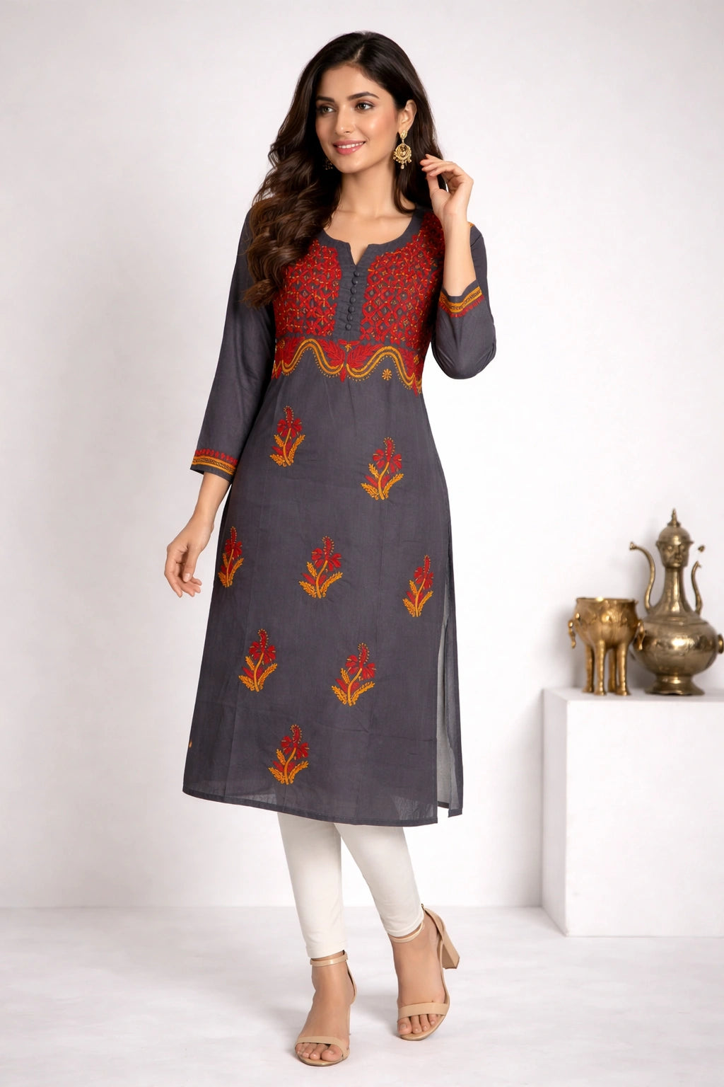 Woman wearing a chikank kadhai gray kurta with red and orange patterns on a white background