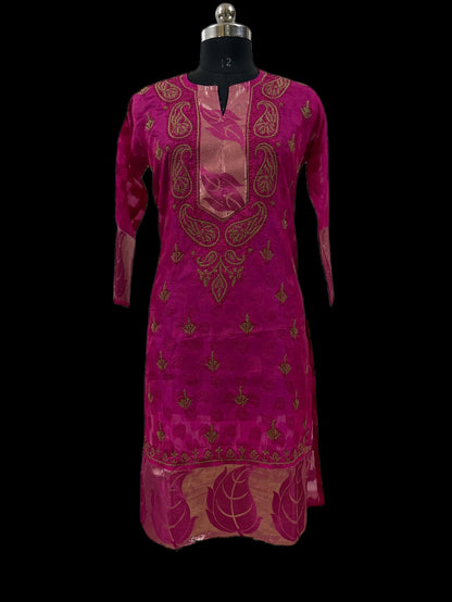 A magenta pink kurta with gold paisley and floral embroidery, displayed on a black dress form mannequin against a solid black background.