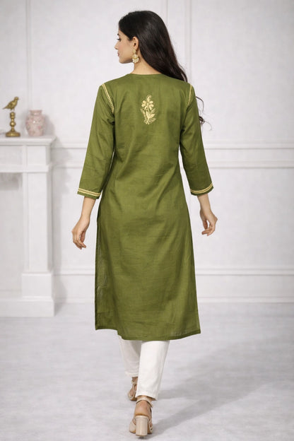 A woman shown from the back wearing an olive green kurta with gold floral embroidery on the upper back and gold-trimmed cuffs, paired with white pants in a bright indoor setting.