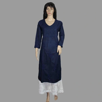 Lucknowi chikankari A dark navy blue long kurta with three-quarter sleeves and a V-neck, displayed on a female mannequin with a white lace skirt, set against a solid gray background.