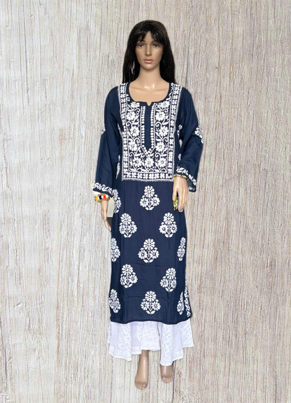 lucknowi chikankari Mannequin wearing a navy blue dress with white patterns in a fabric store.