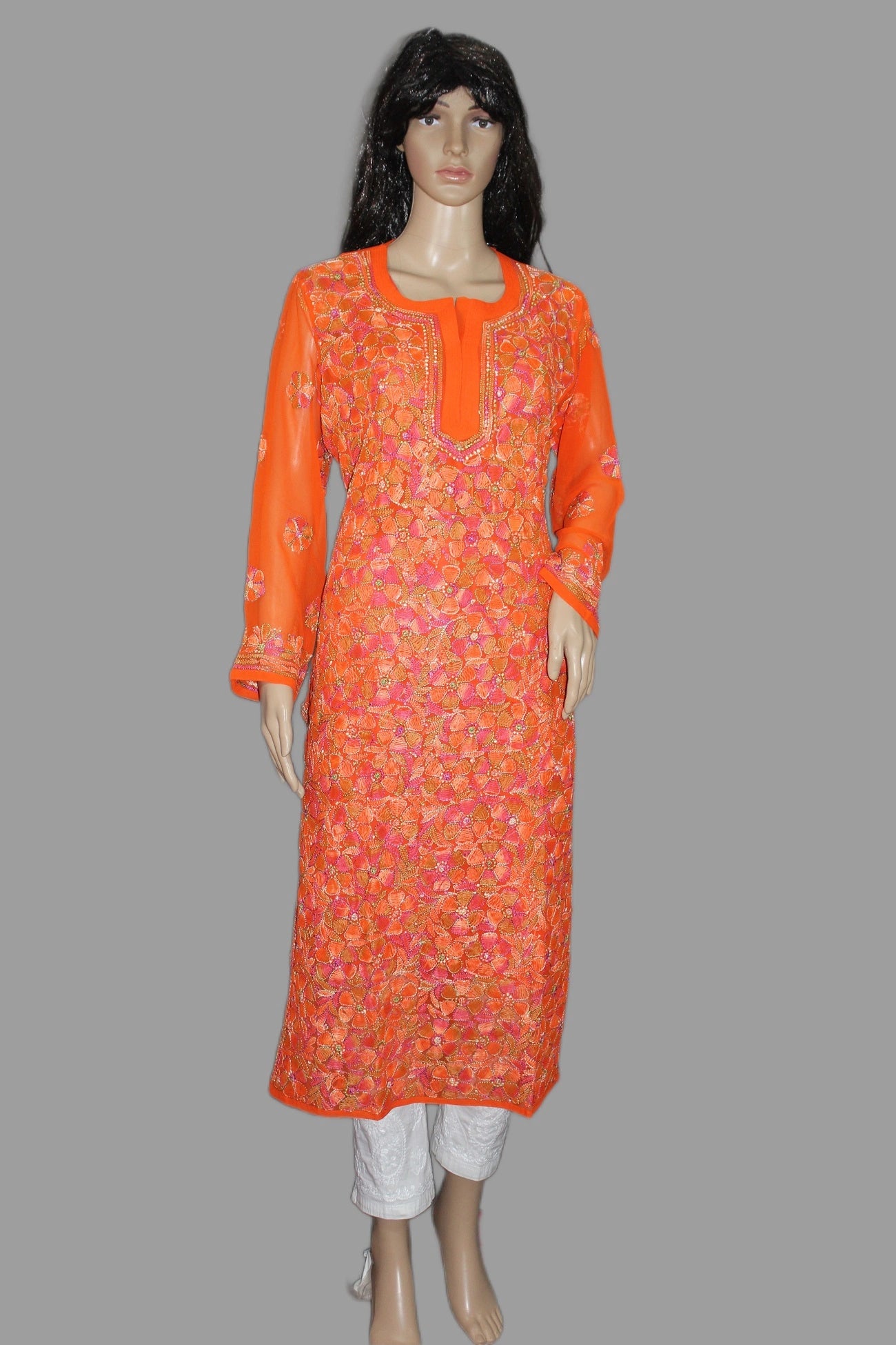 Orange patterned kurta on a mannequin against a gray background
