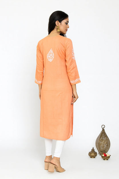 women wearing a lucknowi chikankari Peach embroidered dress  against a gray background