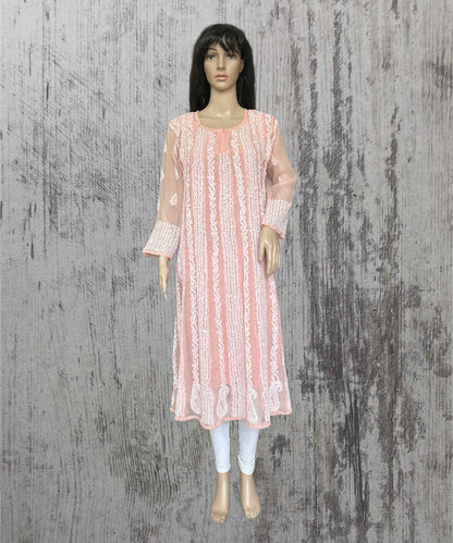 lucknowi chikankari Mannequin wearing a pink lace dress against a textured gray background