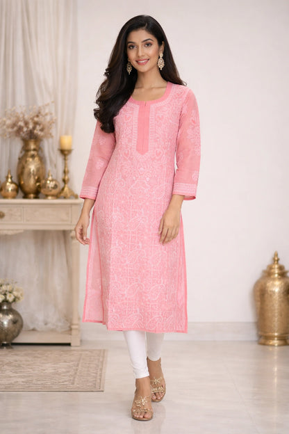 Woman wearing a pink kurta with white pants in an indoor setting