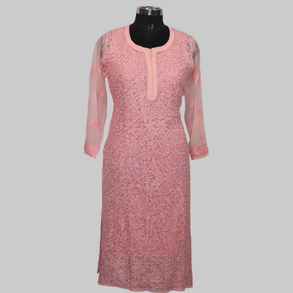 Pink embroidered dress on a mannequin against a gray background