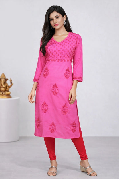 Woman wearing a lucknowi chikankari pink kurta with red pants on a white background
