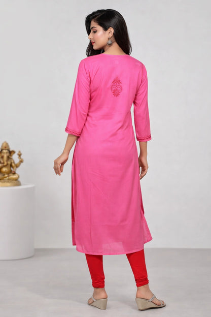 Woman wearing a lucknowi chikankari pink kurta with red pants against a white background
