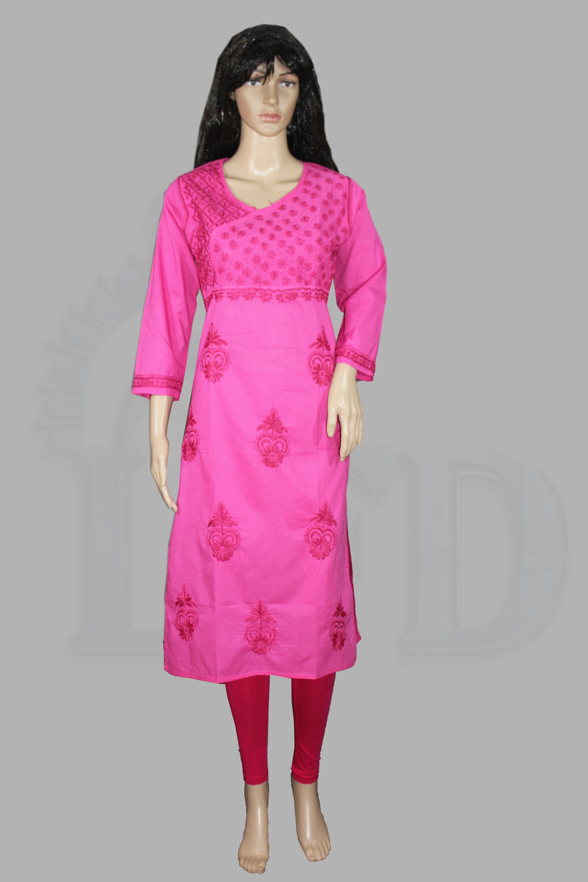 Mannequin wearing a lucknowi chikankari bright pink traditional outfit with intricate designs on a gray background