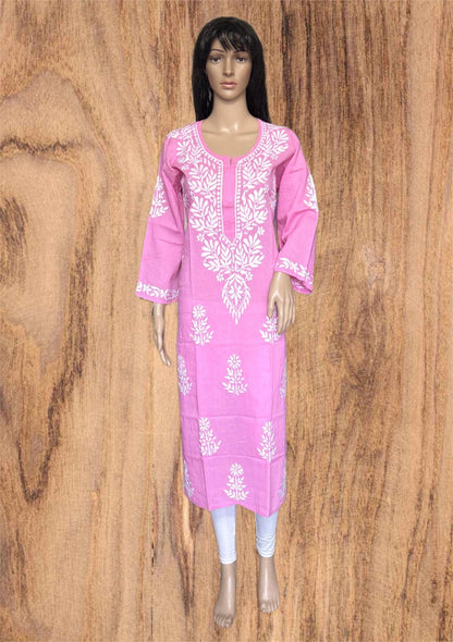 A pink long kurta with white floral embroidery, displayed on a female mannequin against a brown wood-grain background.