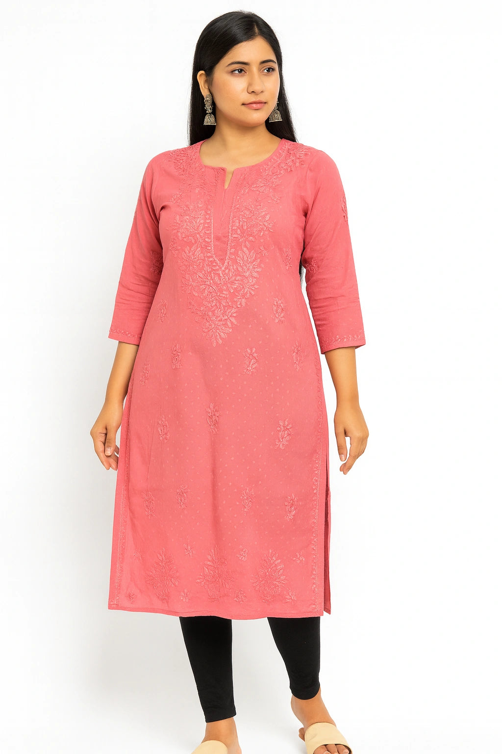 Woman wearing a lucknowi chikankari pink kurta with black leggings on a white background