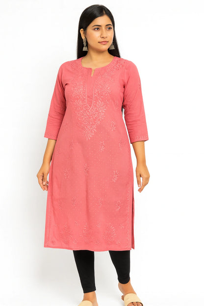 Woman wearing a lucknowi chikankari pink kurta with black leggings on a white background