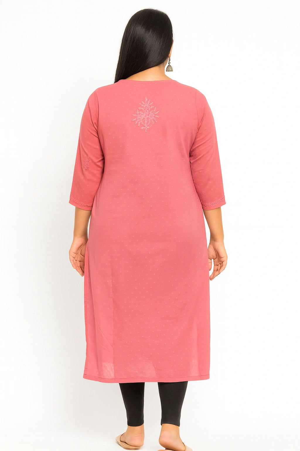 Woman wearing a lucknowi chikankari pink kurta with a white background