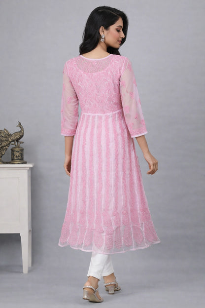 Woman wearing a lucknowi kadhai pink traditional outfit with white pants against a gray background