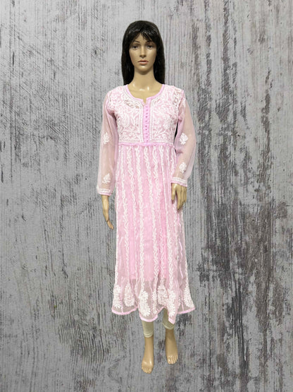 Mannequin wearing a pink lace dress against a textured gray background