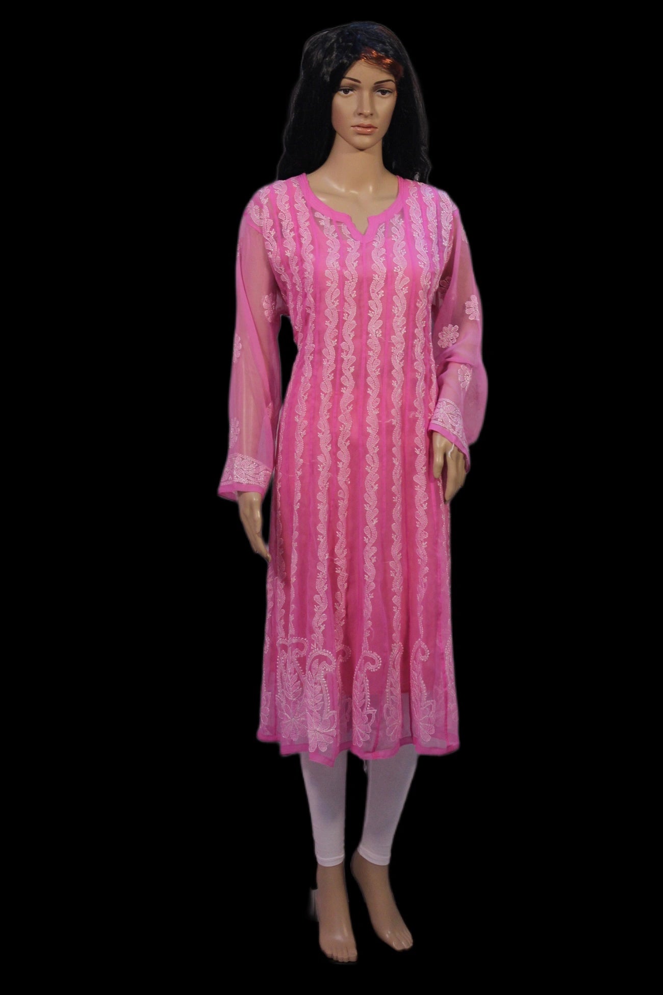 Mannequin wearing a pink dress with white patterns on a black background