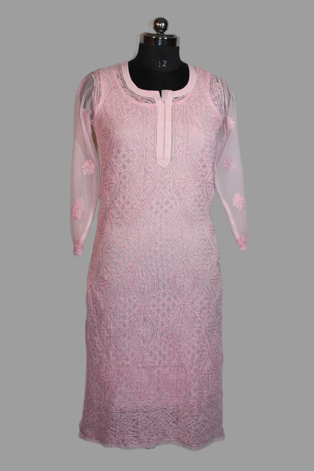 lucknowi chikankari Pink lace dress on a mannequin against a gray background