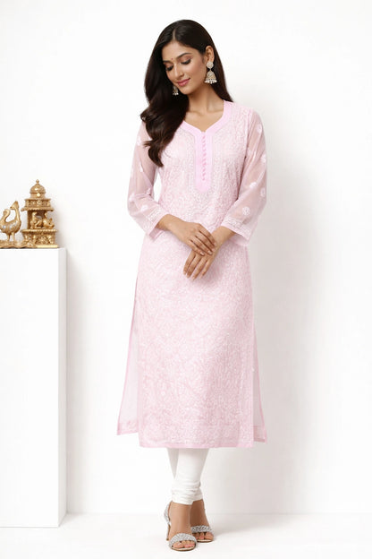 Woman wearing a lucknowi chikankari light pink kurta with a matching jacket on a white background
