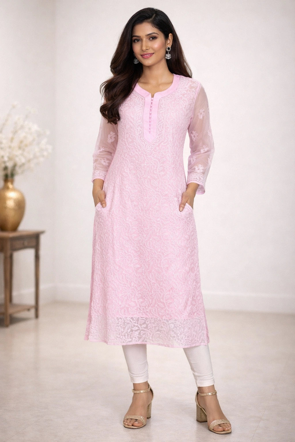 Woman wearing a chikan light pink kurta with white pants in a minimalistic setting
