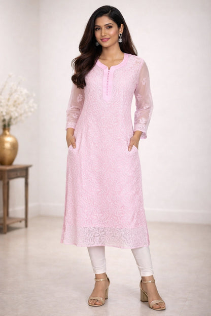 Woman wearing a chikan light pink kurta with white pants in a minimalistic setting