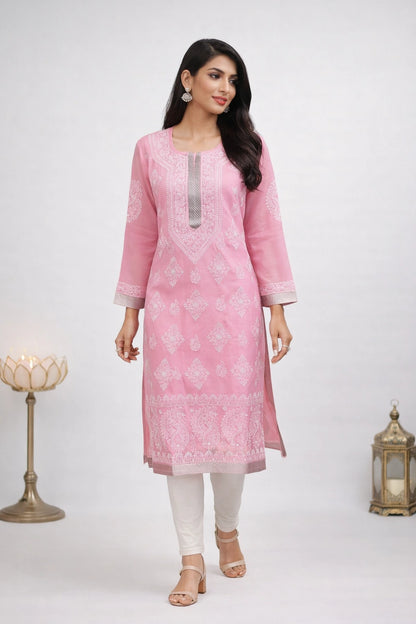 Woman wearing a pink kurta with white patterns of lucknowi embroidery on a white background